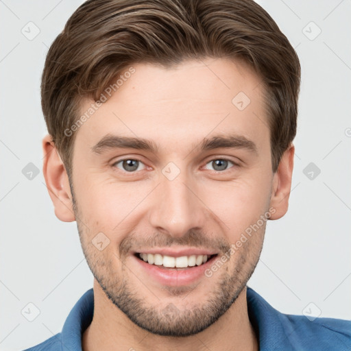 Joyful white young-adult male with short  brown hair and grey eyes