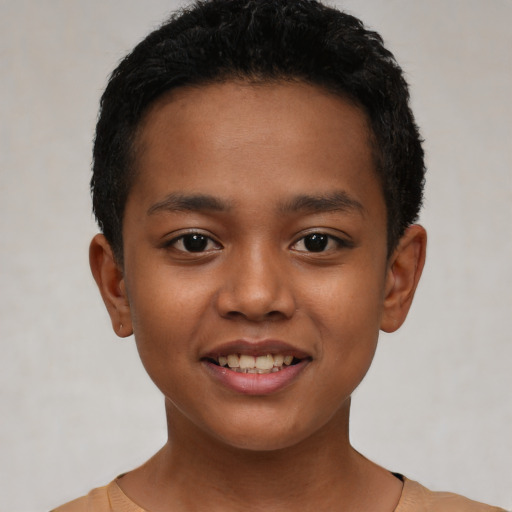 Joyful latino child male with short  black hair and brown eyes