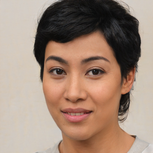 Joyful asian young-adult female with medium  black hair and brown eyes