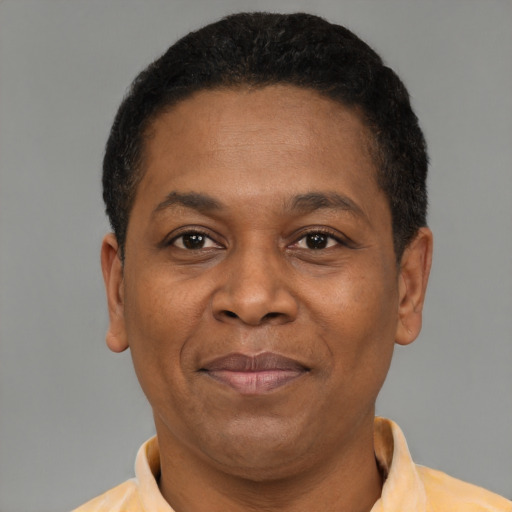 Joyful latino adult male with short  brown hair and brown eyes