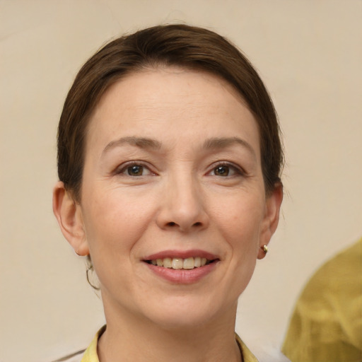 Joyful white adult female with short  brown hair and brown eyes