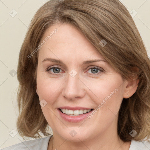 Joyful white adult female with medium  brown hair and blue eyes