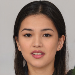 Joyful asian young-adult female with long  brown hair and brown eyes