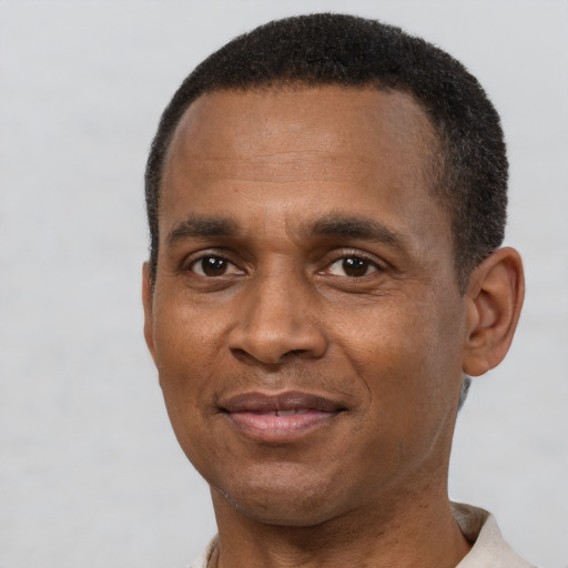 Joyful latino adult male with short  brown hair and brown eyes