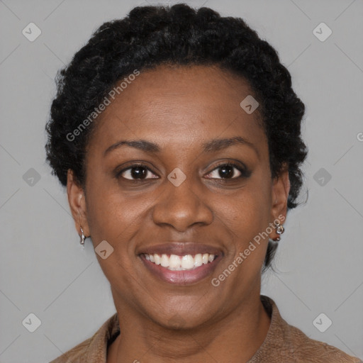 Joyful black adult female with short  brown hair and brown eyes