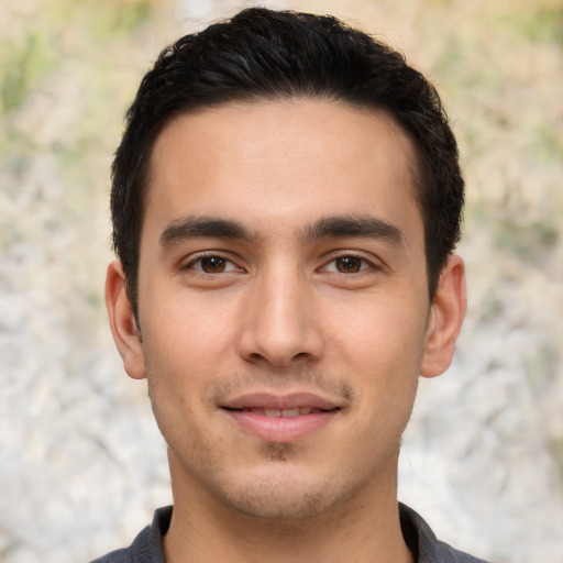 Joyful white young-adult male with short  black hair and brown eyes