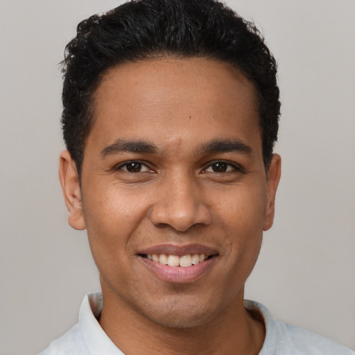 Joyful latino young-adult male with short  black hair and brown eyes