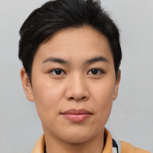 Joyful asian young-adult female with short  brown hair and brown eyes