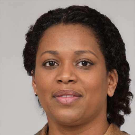 Joyful black adult female with medium  black hair and brown eyes