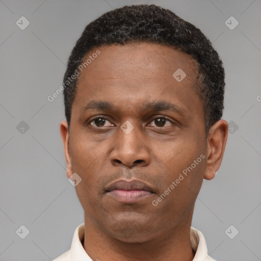 Neutral latino young-adult male with short  brown hair and brown eyes