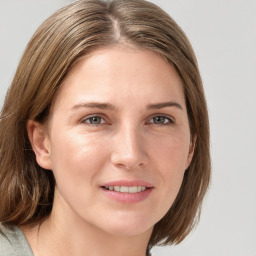 Joyful white young-adult female with medium  brown hair and blue eyes