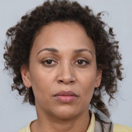 Joyful black adult female with medium  brown hair and brown eyes