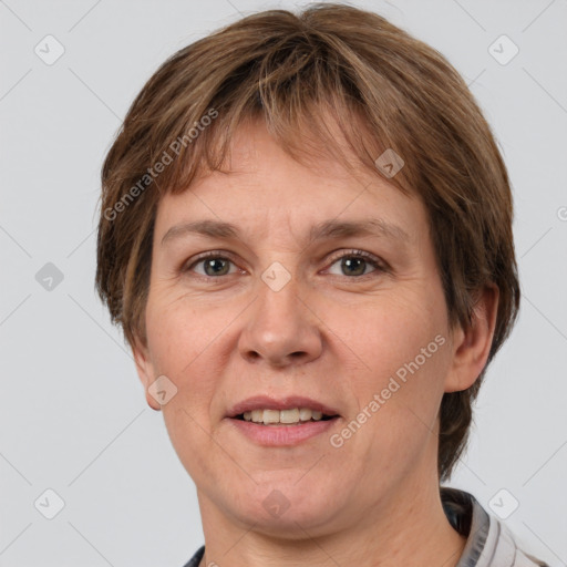 Joyful white adult female with short  brown hair and grey eyes