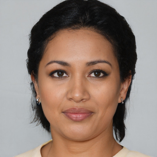 Joyful latino young-adult female with medium  black hair and brown eyes