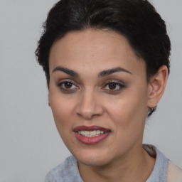 Joyful latino young-adult female with short  brown hair and brown eyes