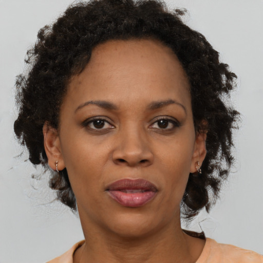 Joyful black adult female with short  brown hair and brown eyes