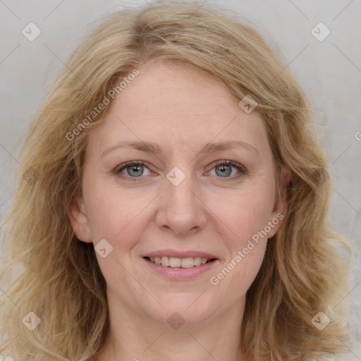 Joyful white adult female with medium  brown hair and blue eyes