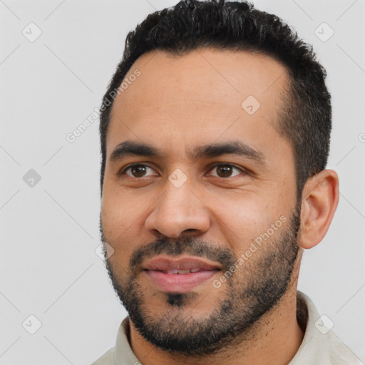 Joyful latino young-adult male with short  black hair and brown eyes