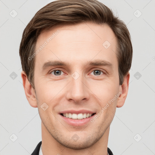 Joyful white young-adult male with short  brown hair and grey eyes