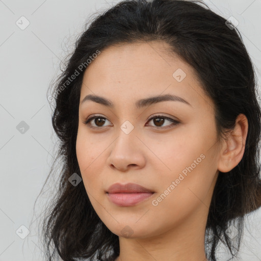 Joyful latino young-adult female with long  brown hair and brown eyes