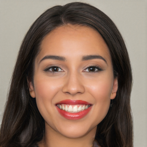 Joyful latino young-adult female with long  brown hair and brown eyes