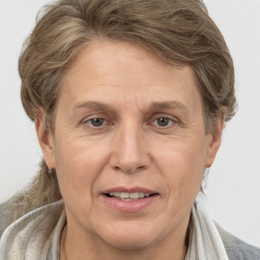 Joyful white adult female with medium  brown hair and grey eyes