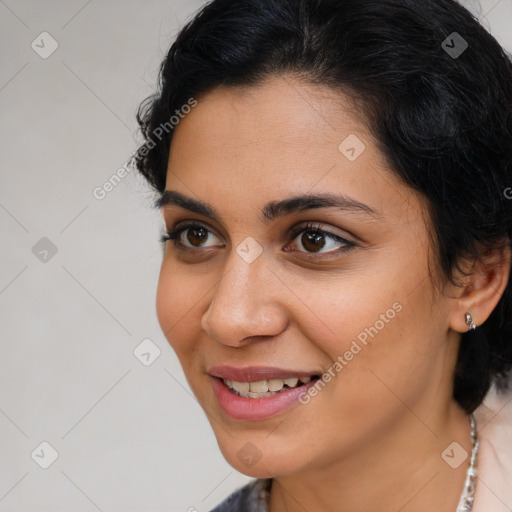 Joyful latino young-adult female with medium  brown hair and brown eyes