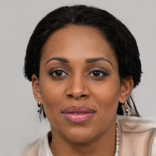 Joyful black adult female with medium  black hair and brown eyes