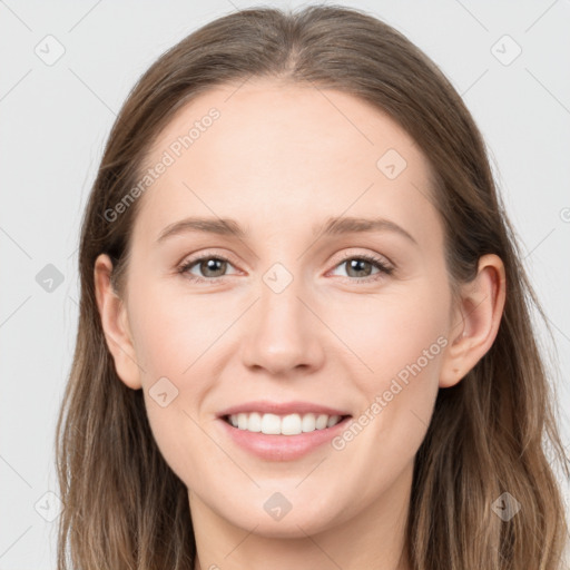 Joyful white young-adult female with long  brown hair and grey eyes