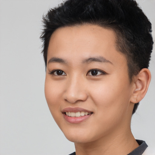 Joyful asian young-adult female with short  black hair and brown eyes