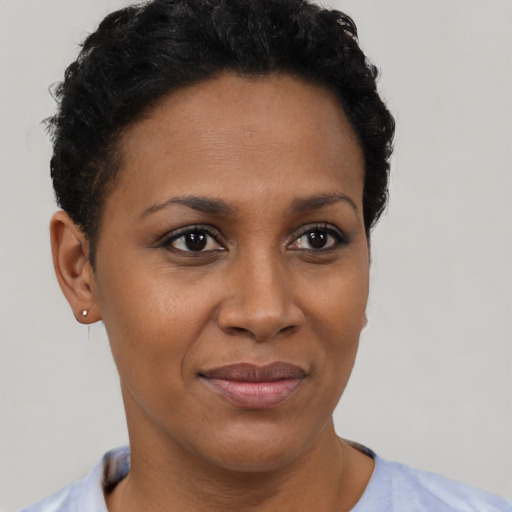 Joyful black young-adult female with short  brown hair and brown eyes