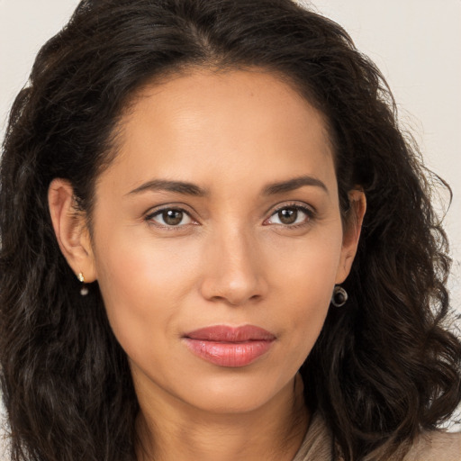 Joyful white young-adult female with long  brown hair and brown eyes