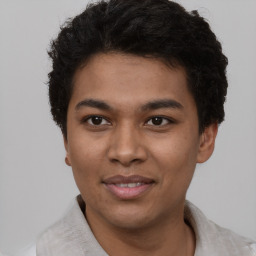 Joyful latino young-adult male with short  brown hair and brown eyes