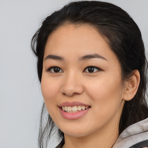 Joyful asian young-adult female with medium  black hair and brown eyes