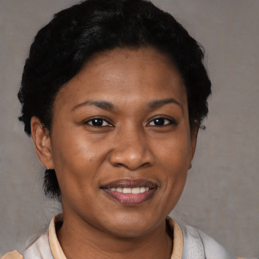 Joyful latino adult female with short  black hair and brown eyes