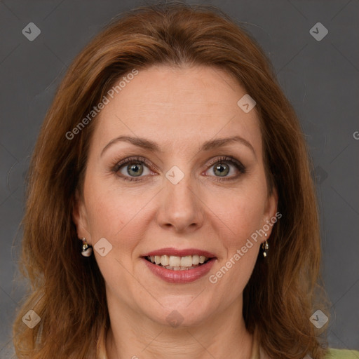 Joyful white adult female with medium  brown hair and green eyes