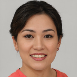 Joyful asian young-adult female with short  brown hair and brown eyes