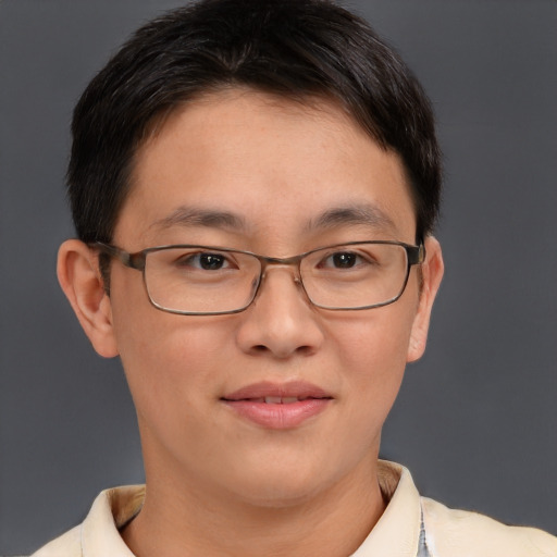 Joyful asian adult male with short  brown hair and brown eyes