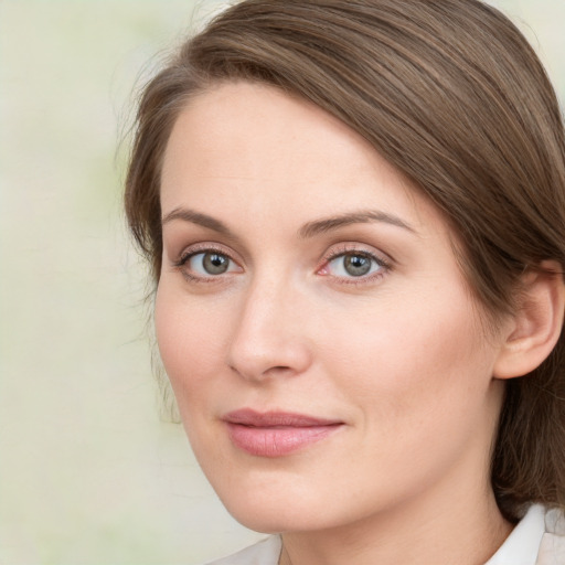 Joyful white young-adult female with medium  brown hair and green eyes