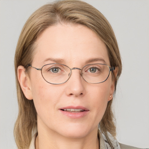 Joyful white adult female with medium  brown hair and blue eyes