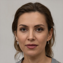 Joyful white adult female with medium  brown hair and brown eyes