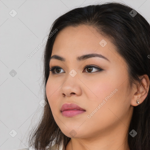 Joyful asian young-adult female with long  brown hair and brown eyes