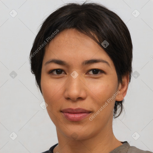 Joyful asian young-adult female with short  black hair and brown eyes