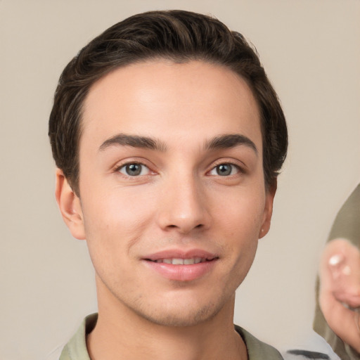 Joyful white young-adult male with short  brown hair and brown eyes