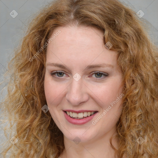 Joyful white young-adult female with medium  brown hair and green eyes