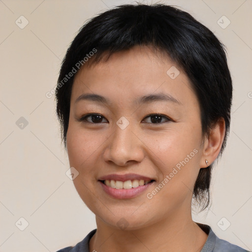 Joyful asian young-adult female with medium  brown hair and brown eyes