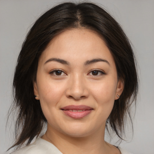 Joyful asian young-adult female with medium  brown hair and brown eyes