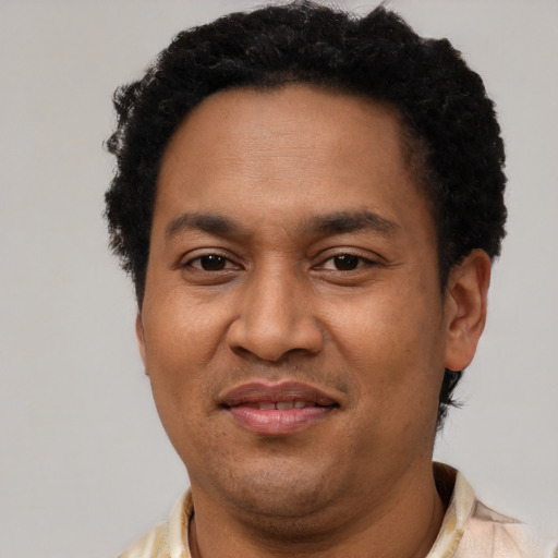 Joyful latino adult male with short  brown hair and brown eyes