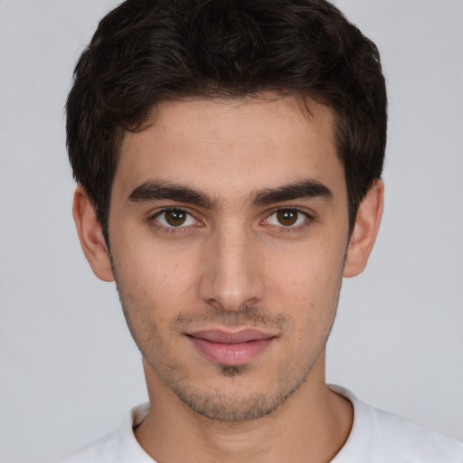 Joyful white young-adult male with short  brown hair and brown eyes