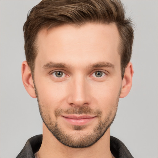 Joyful white young-adult male with short  brown hair and grey eyes